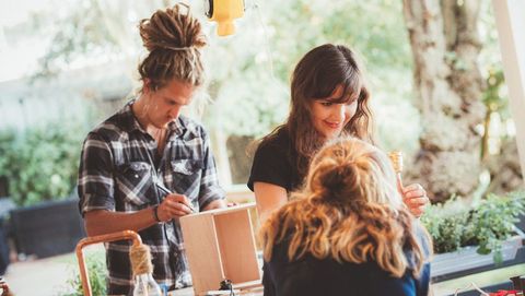 A man and two women are participating in a craft workshop.