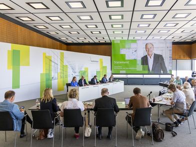 A Group of people sits in a conference room for the finance press conference