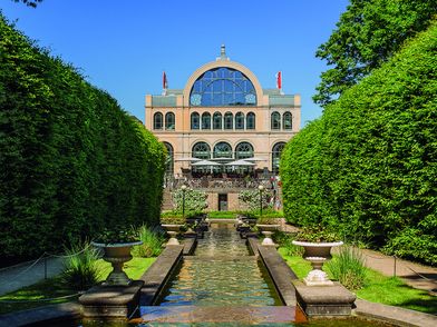 Terrace of Dank Augusta in Flora Cologne. View of the botanical garden and fountain.