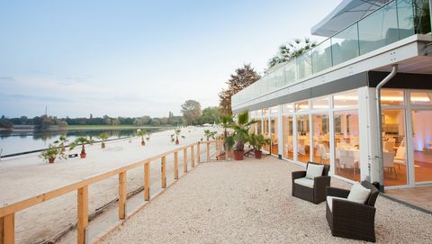Outdoor location in Cologne; lakeside pavilion on Lake Fühlinger See with a view of the beach